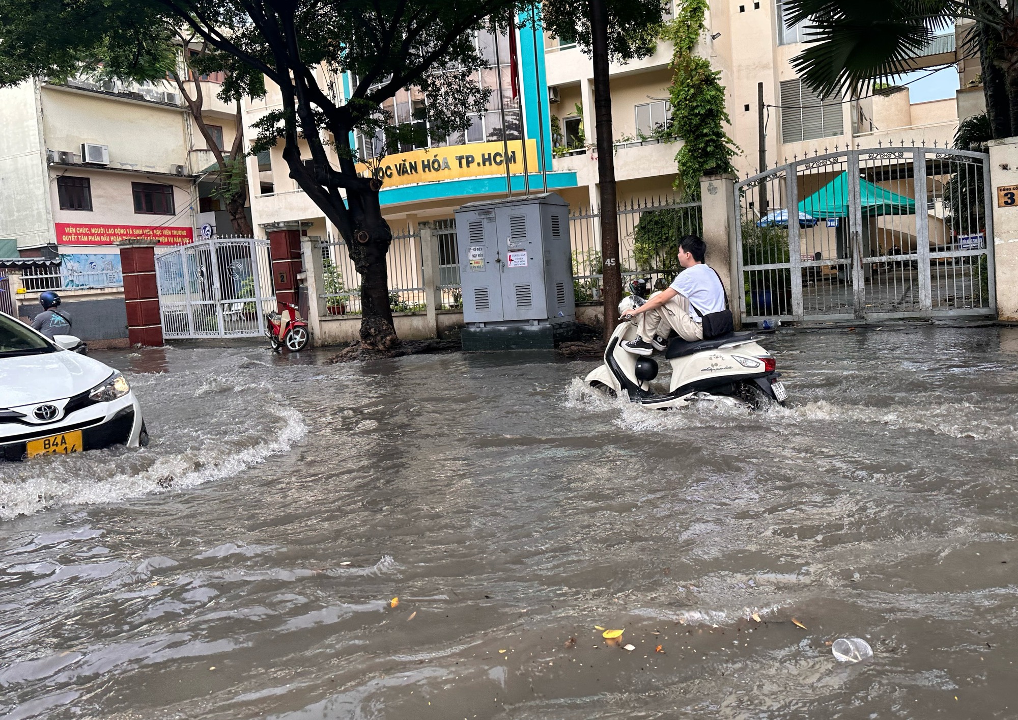 Mưa cực to, 'phố nhà giàu' TP.HCM mênh mông biển nước: Người xe bì bõm lội nước - Ảnh 2.