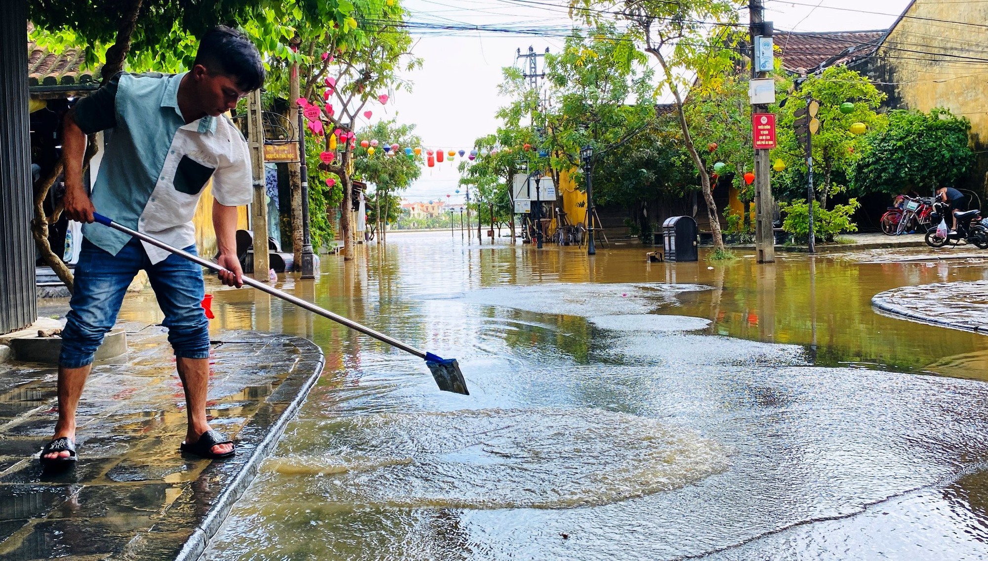 Tranh thủ lũ rút, người dân Hội An tất bật dọn bùn non để đón du khách - Ảnh 9.