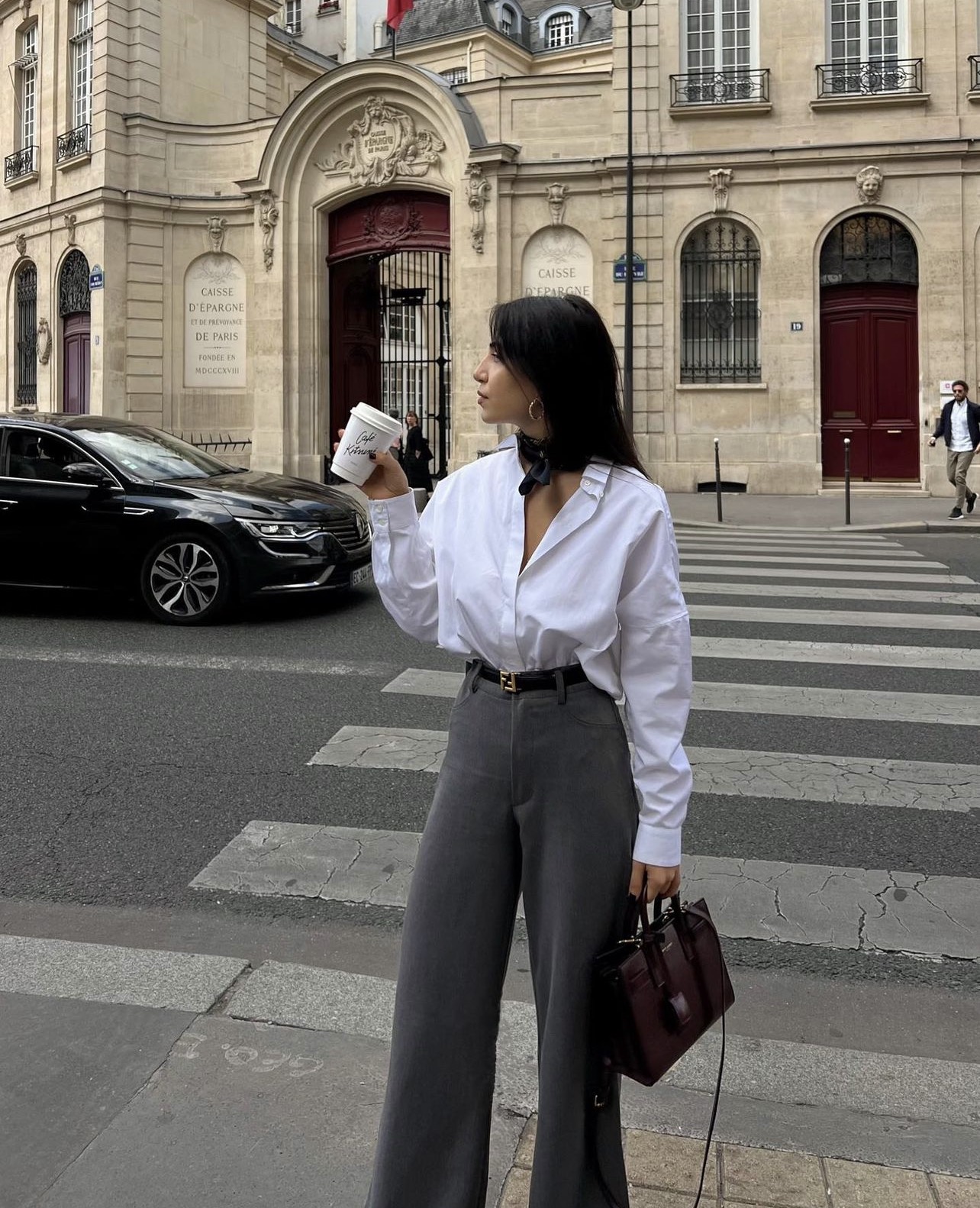 Oversized white button-up tucked into high-rise wide trousers