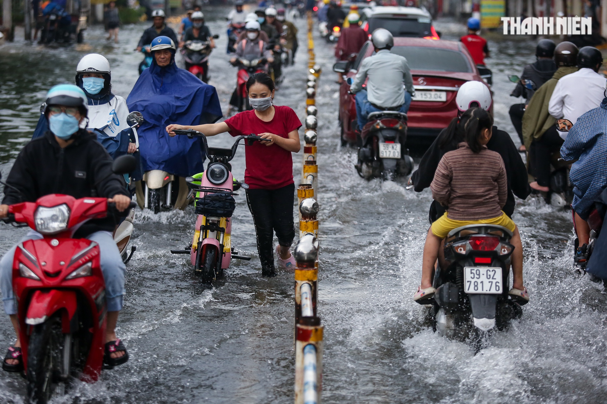 Đường TP.HCM ngập lênh láng sau mưa, người dân vất vả lội nước về nhà - Ảnh 1.