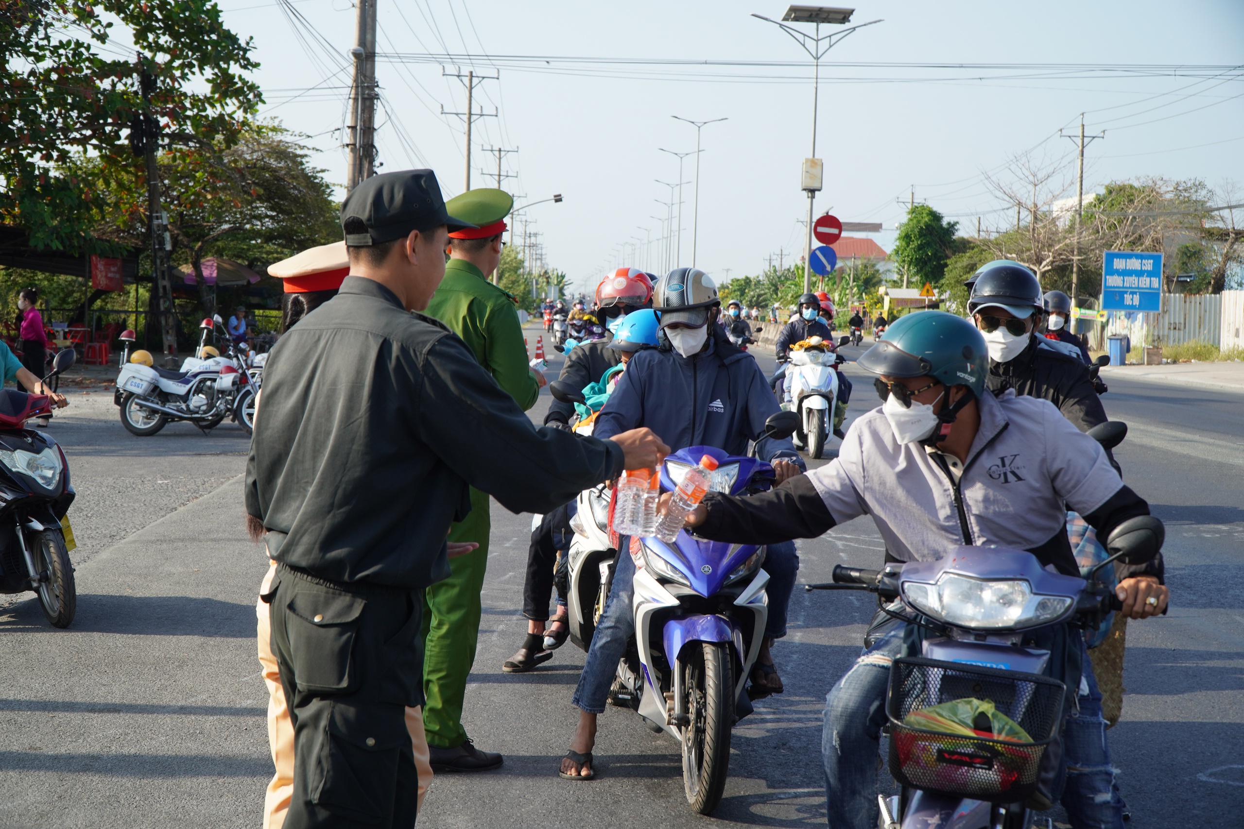 CSGT phát nước, sữa cho người dân rời quê trên Quốc lộ 1 mùng 5 tết- Ảnh 4.