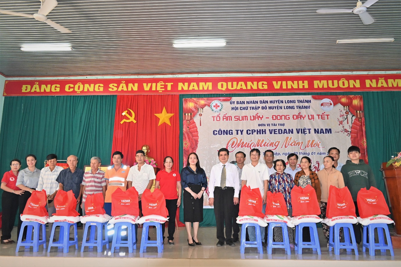 A group of people standing in front of a banner  Description automatically generated