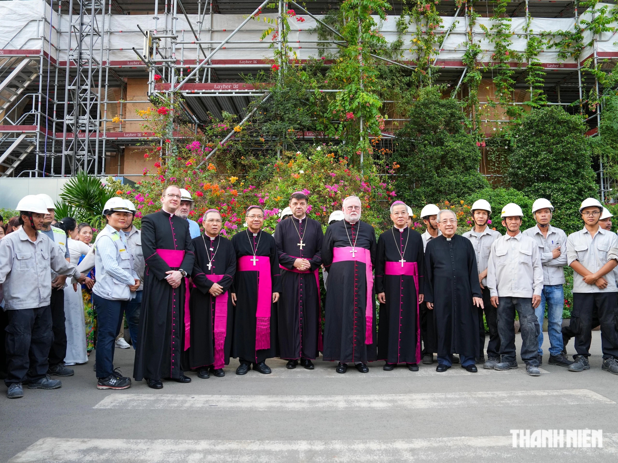 Tổng giám mục Paul Richard Gallagher chụp ảnh kỷ niệm cùng kỹ sư và công nhân thực hiện dự án đại trùng tu Nhà thờ Đức Bà Sài Gòn