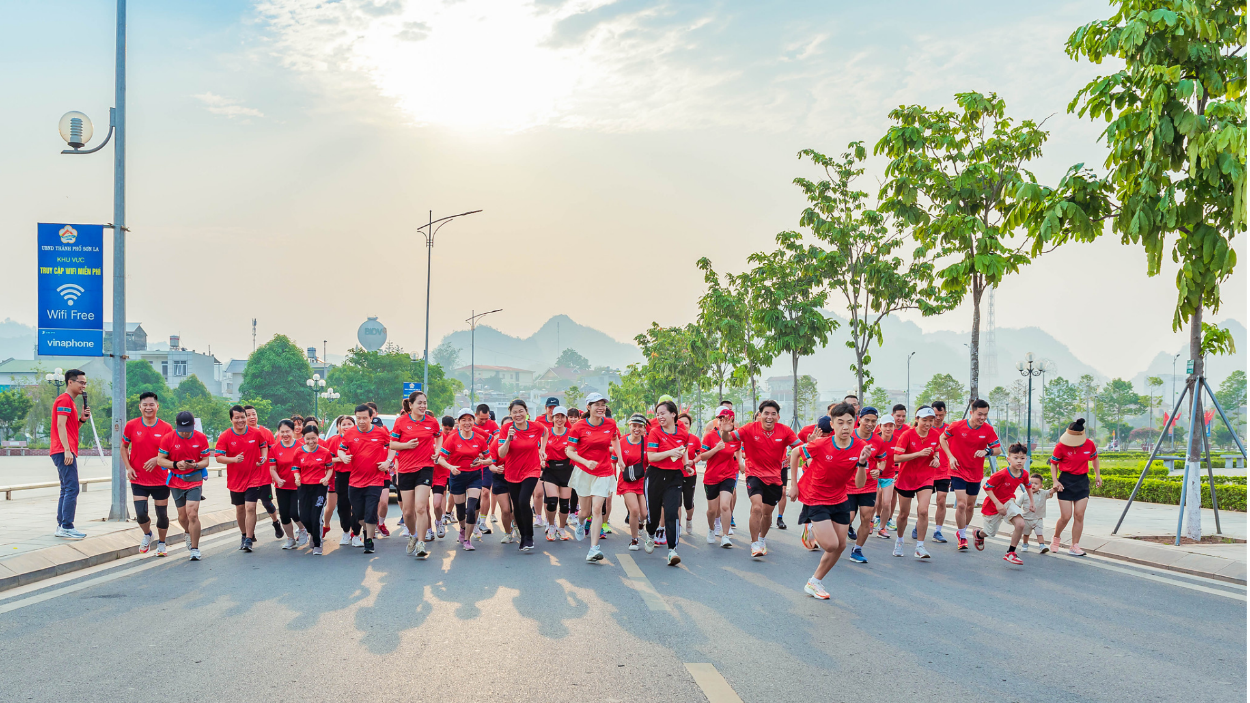 A group of people running on a street  Description automatically generated