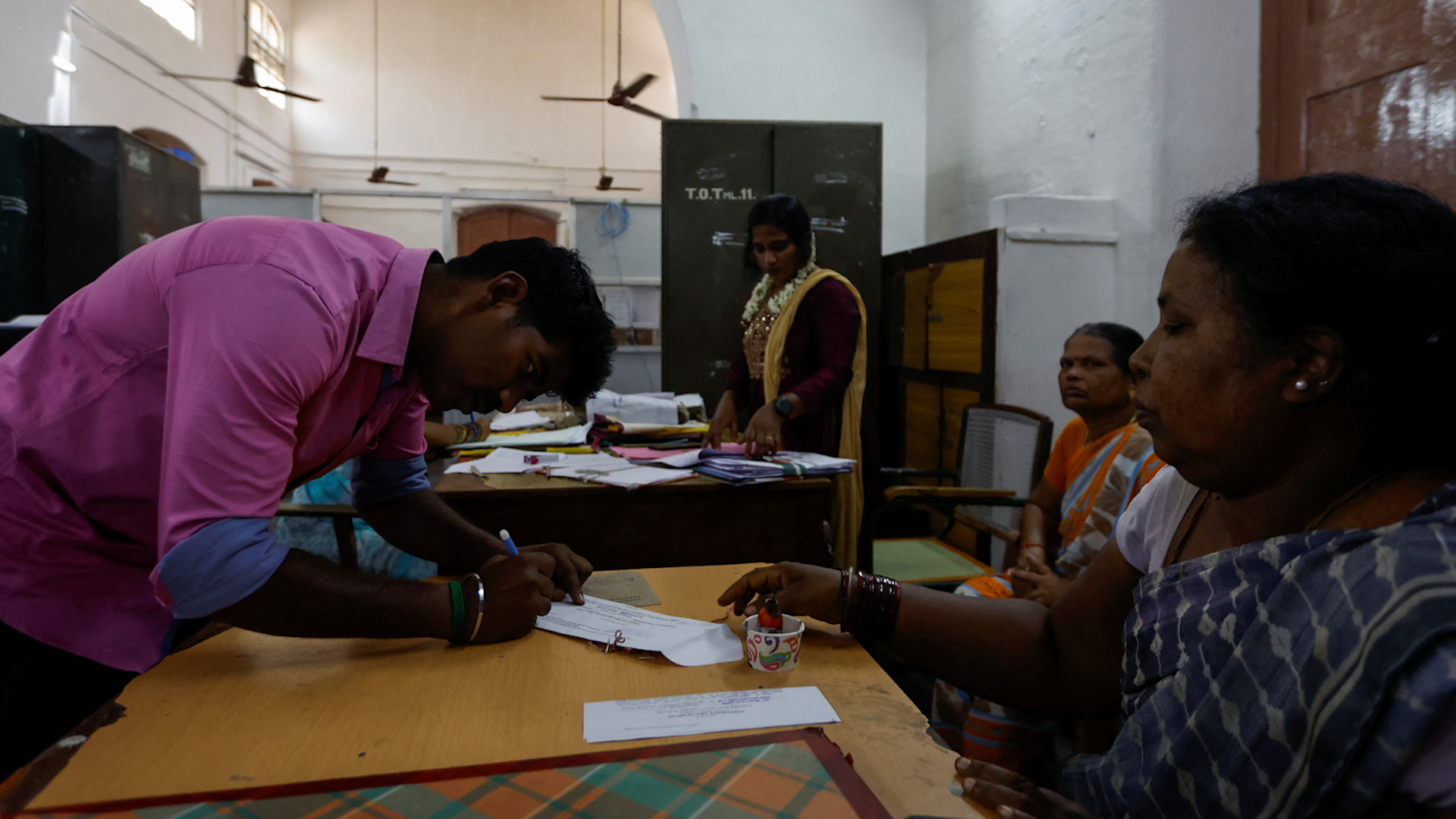 Người dân ký vào tờ khai trước khi bỏ phiếu tại một điểm bỏ phiếu ở Tiruvannamalai (Ấn Độ), ngày 18.4.2024