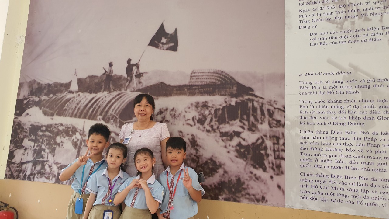 Cô Tạ Thị Thái, Hiệu trưởng nhà trường, cùng các học trò bên tấm ảnh lịch sử được treo trang trọng phía trong trường