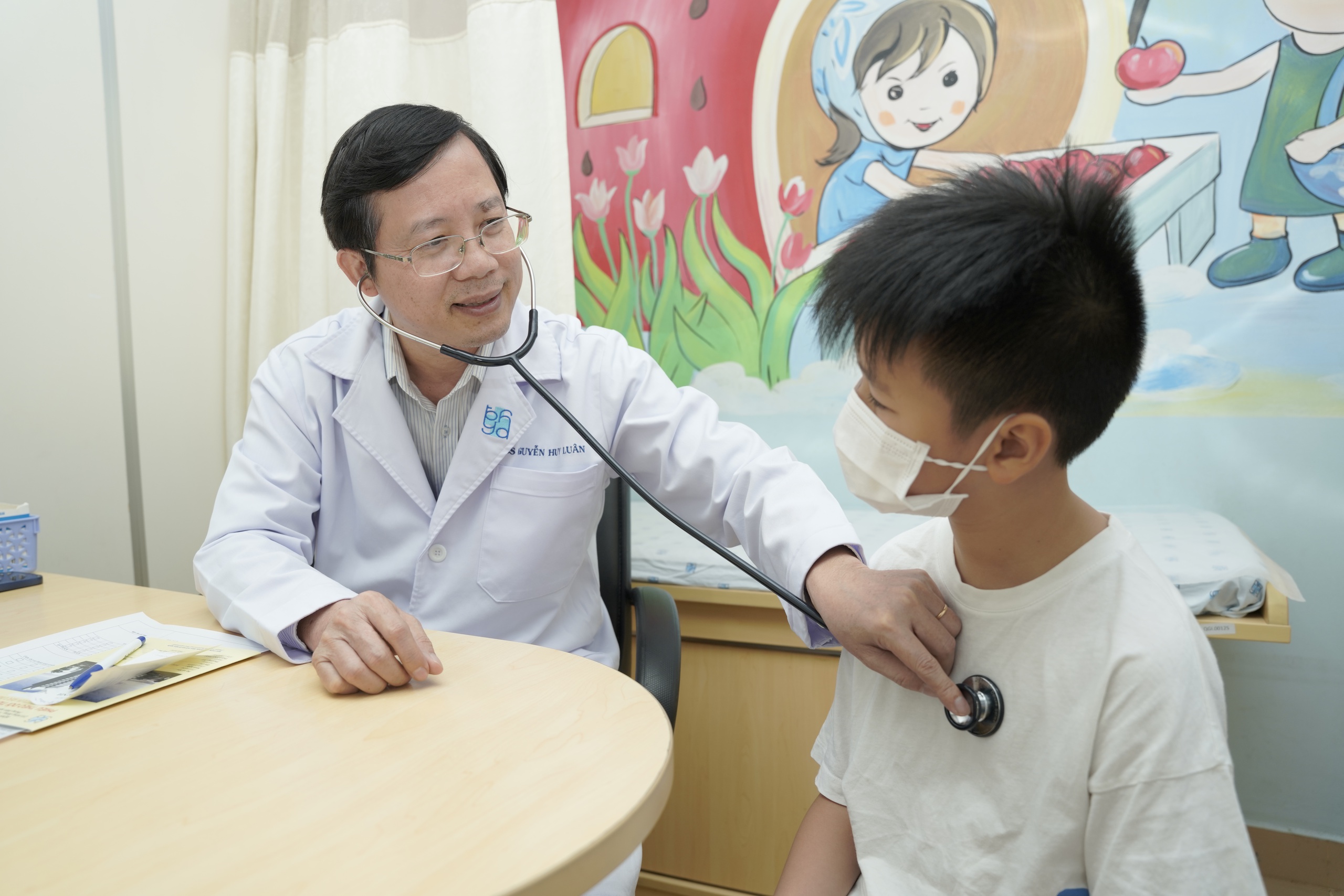 Viêm mũi và tiêm chủng phòng ngừa bệnh hô hấp ở trẻ em- Ảnh 1. TS-BS Nguyễn Huy Luân khám, tư vấn cho trẻ trước khi tiêm chủng