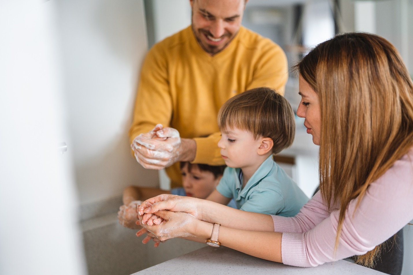 A person and person washing hands  Description automatically generated