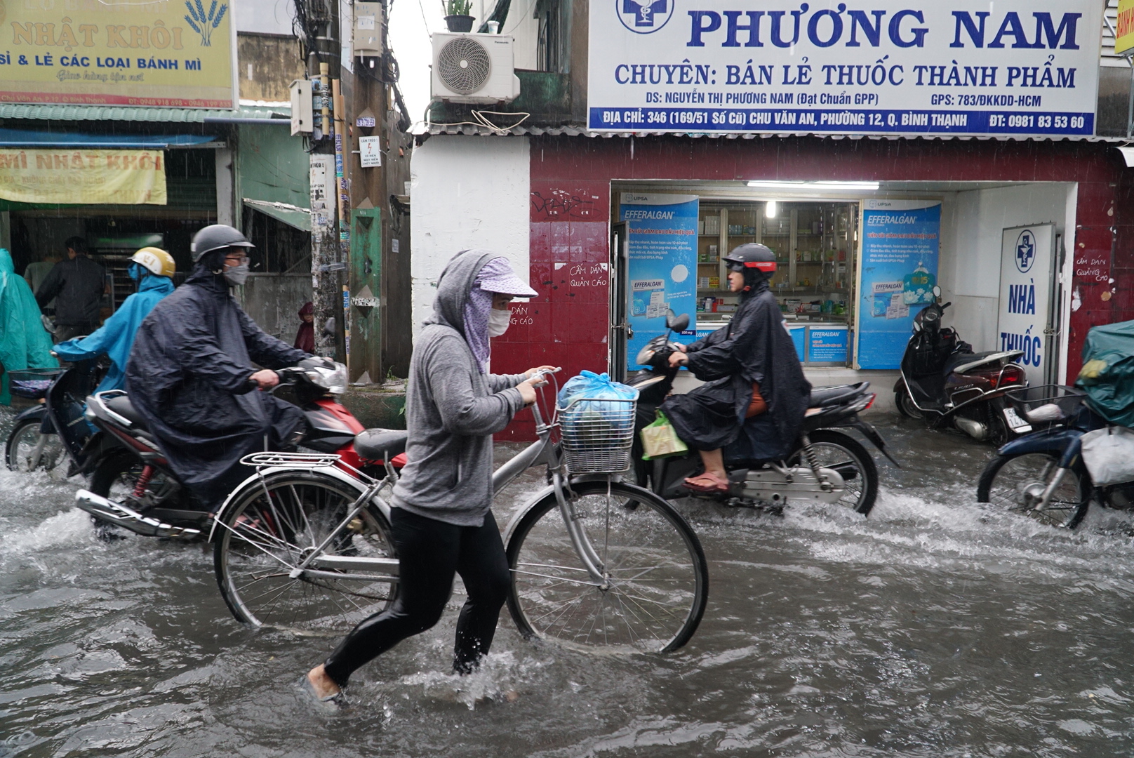 Mưa lớn, người dân ở TP.HCM: Nháo nhào lội nước ngập hơn 1 mét dọn rác, kê bờ bao- Ảnh 1.