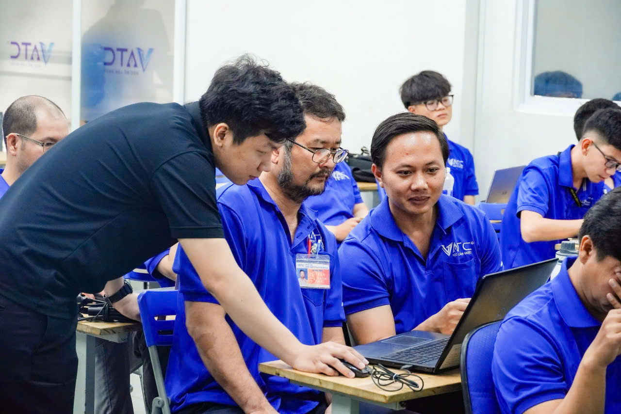 A group of people in blue shirts  Description automatically generated