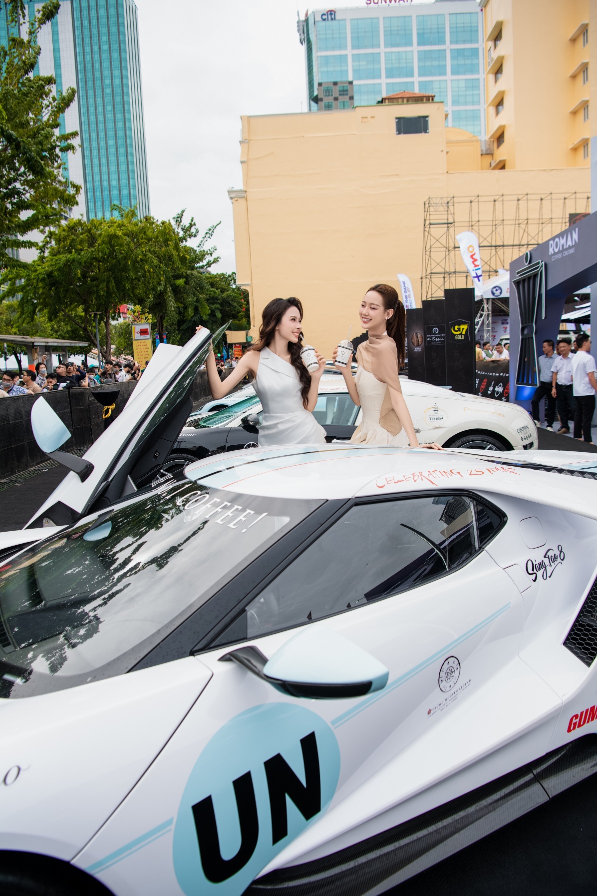 Two women standing next to a car  Description automatically generated