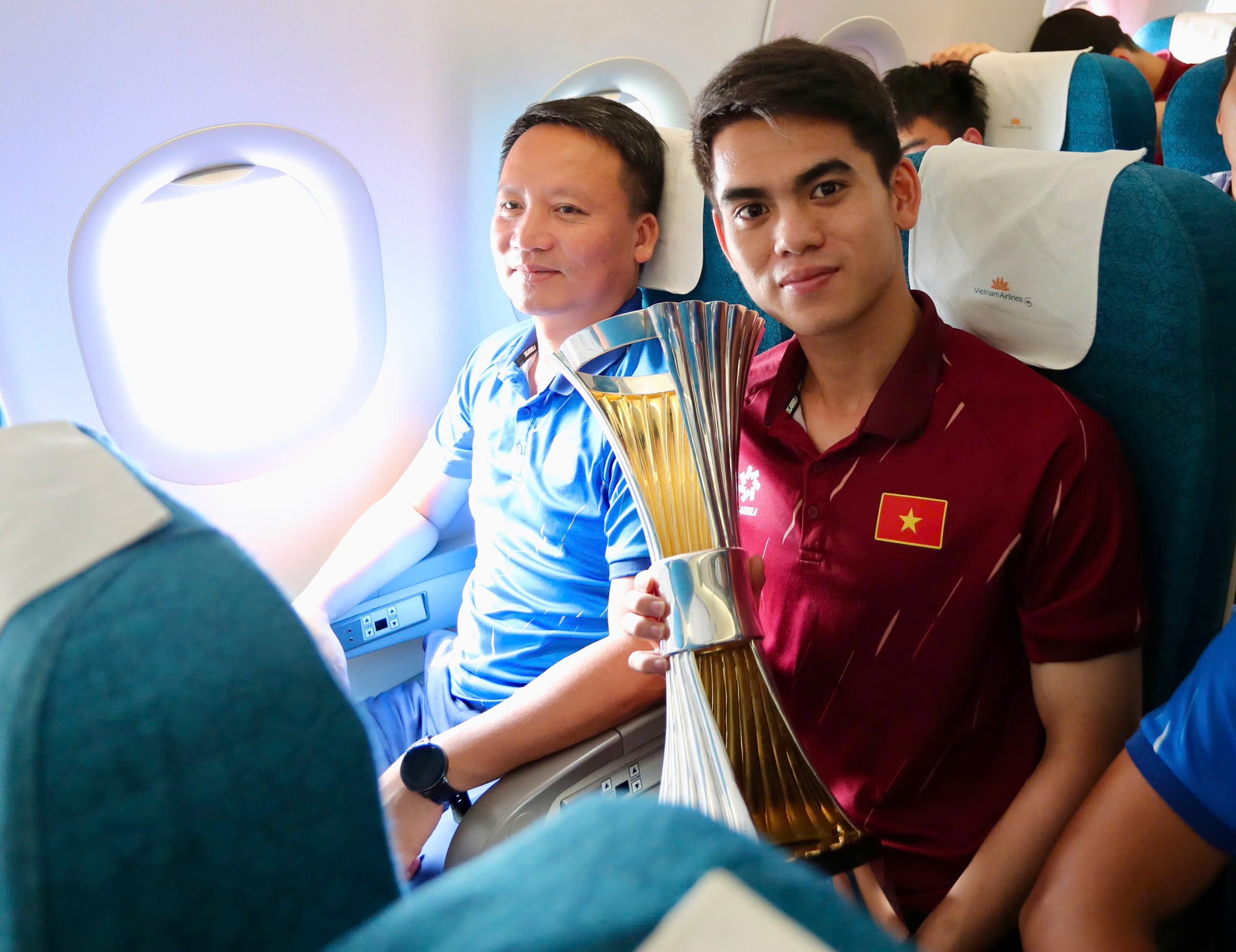 Dinh Bac “តស៊ូ” ដើម្បីដណ្ដើមពានរង្វាន់ អ្នកគាំទ្រឥណ្ឌូណេស៊ីបានសុំប័ណ្ណសម្គាល់ U.23 វៀតណាមនៅព្រលានយន្តហោះ - រូបថត ៤. Đình Bắc ‘khệ nệ’ cầm cúp, CĐV Indonesia xin chữ ký U.23 Việt Nam ở sân bay- Ảnh 4.