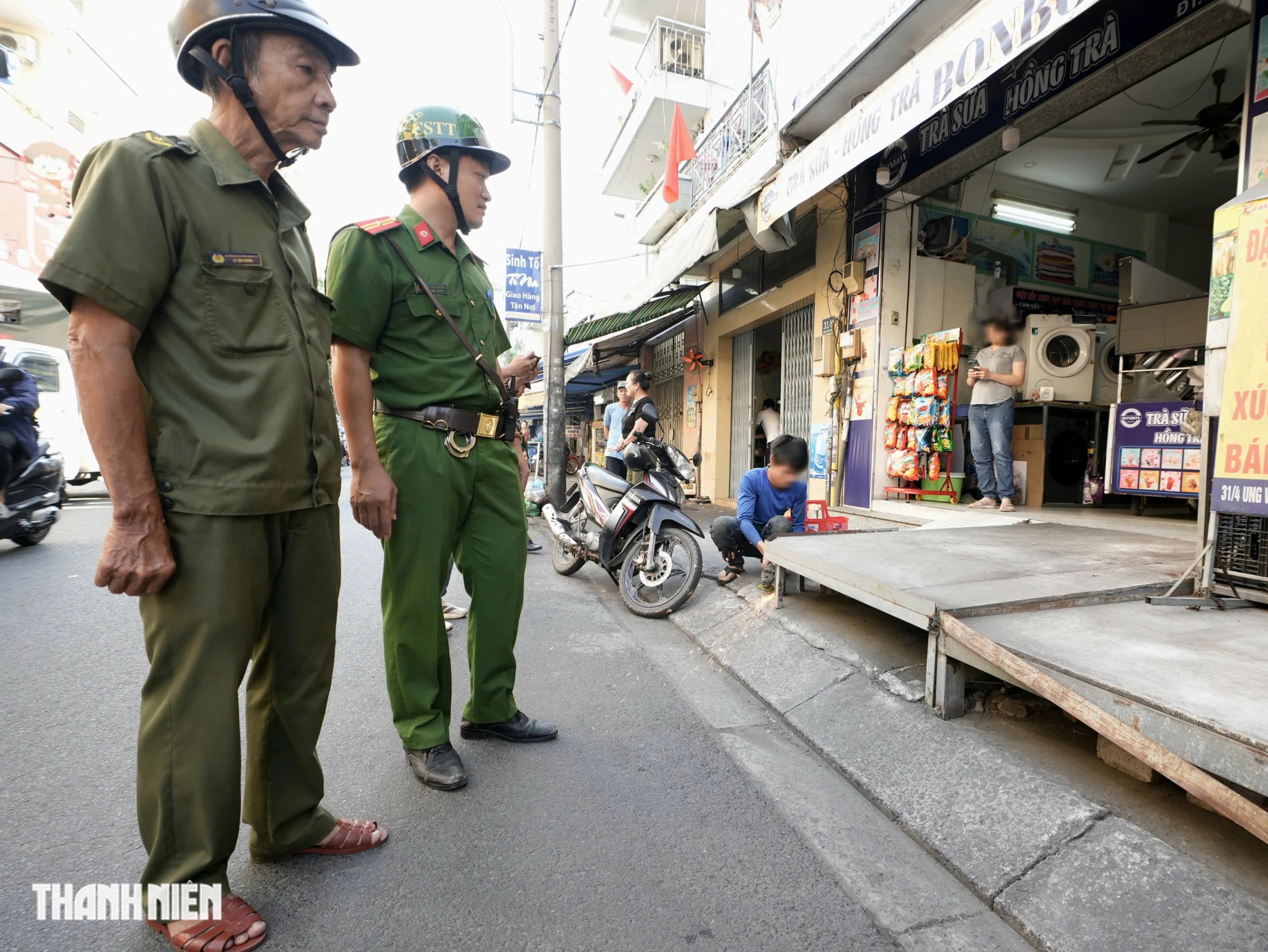 TP.HCM xử lý lấn chiếm vỉa hè: Người dân cất gọn biển hiệu, đường thông thoáng - Ảnh 1.