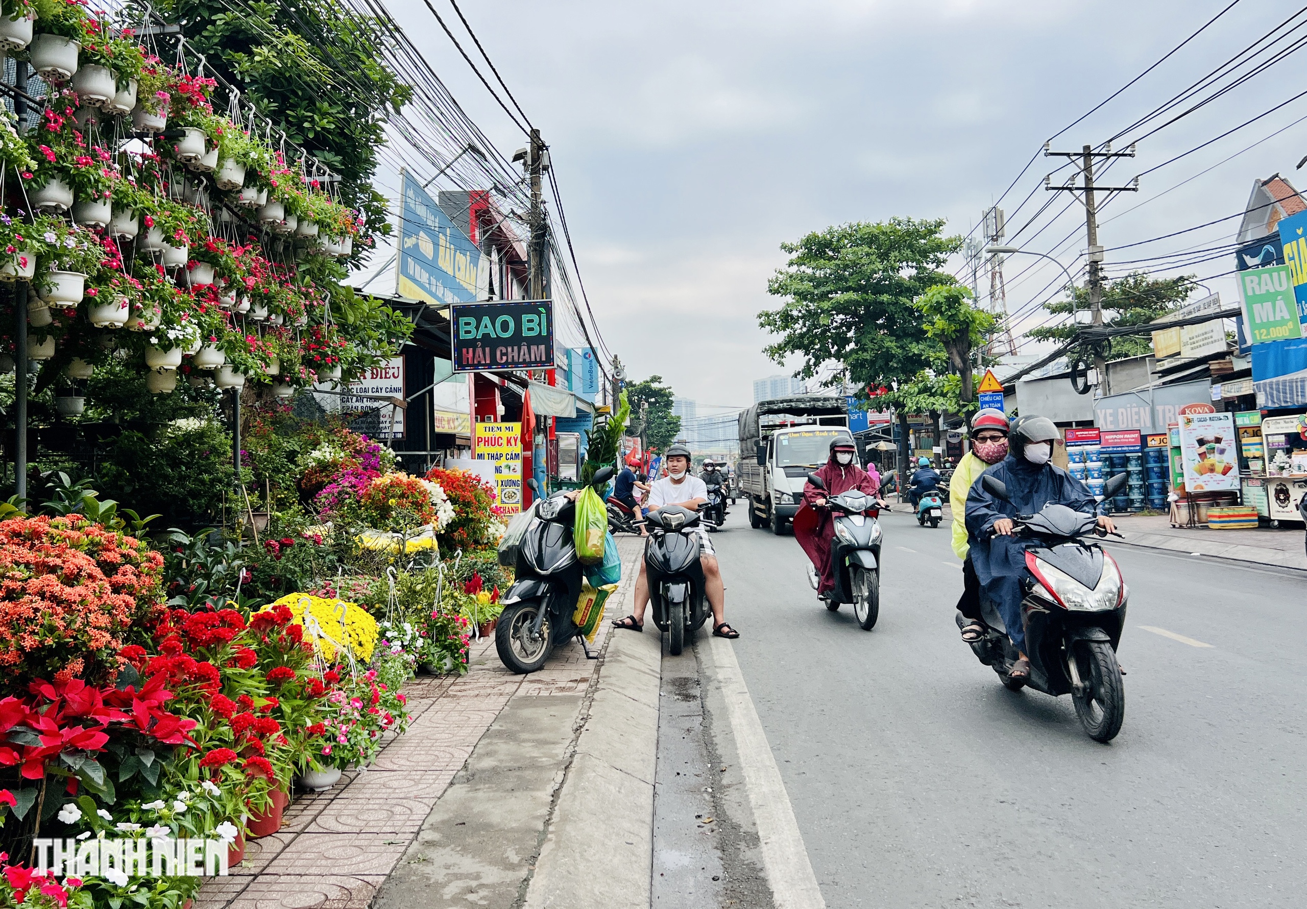 Cảnh lạ 24 th&aacute;ng Chạp , người d&acirc;n TP . HCM đội mưa đi chợ tết - Ảnh 2.
