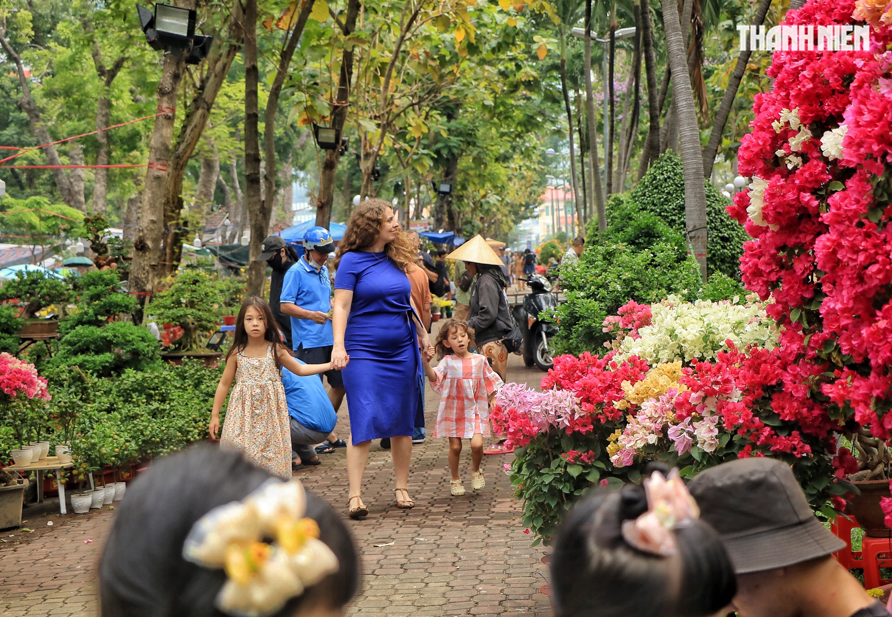 Khách Tây đi chợ hoa tết trung tâm TP.HCM, làm điều lạ khiến nhà vườn tò mò - Ảnh 1.