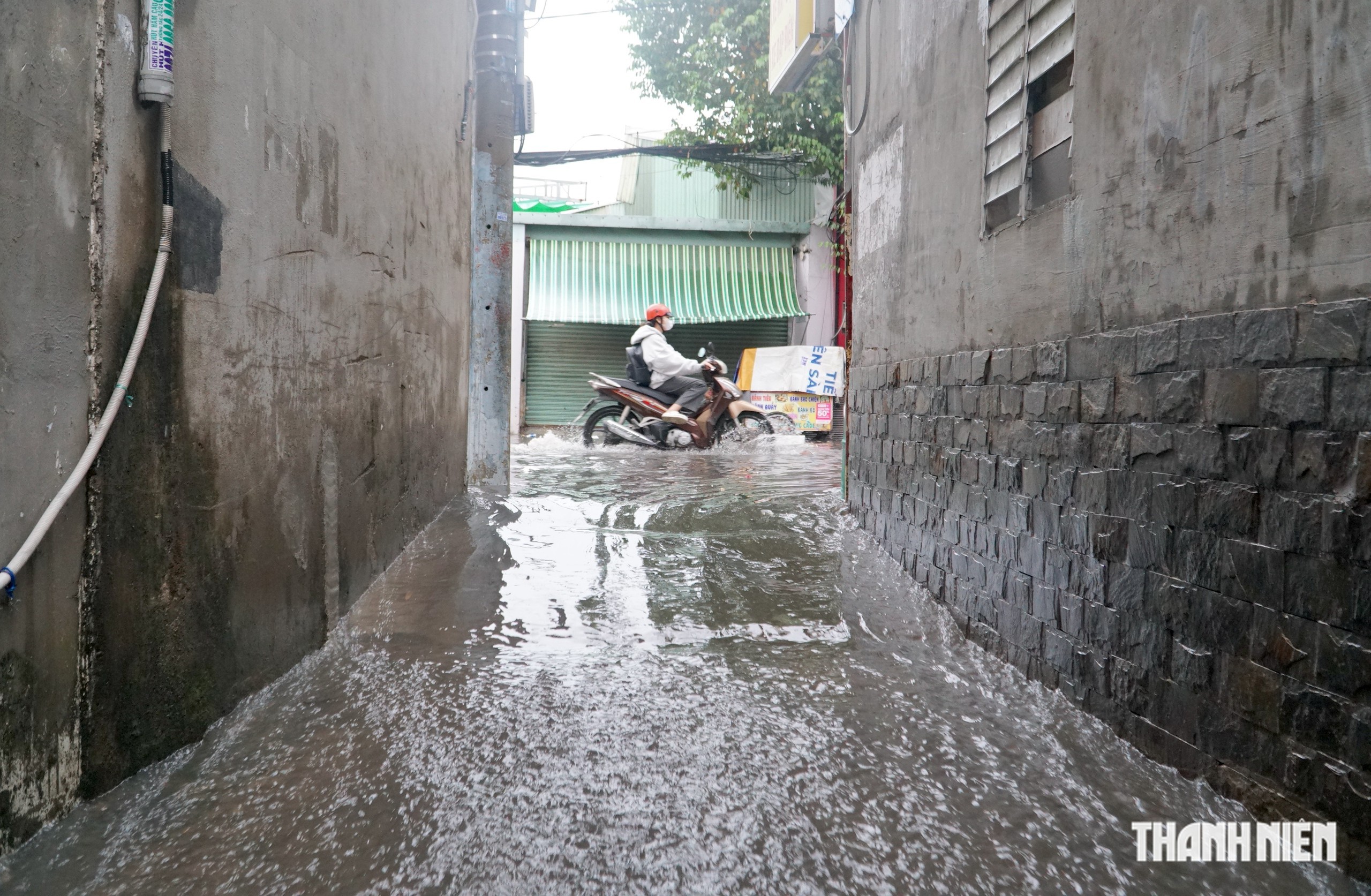 Nhiều tuyến đường lại ngập, người d&acirc;n vất vả dọn dẹp sau cơn mưa lớn ở TP.HCM - Ảnh 8.