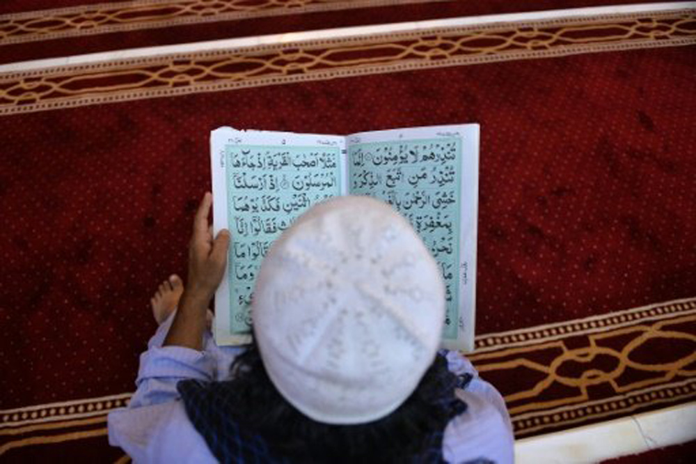 Một cậu bé Pakistan đang đọc kinh - Ảnh: AFP