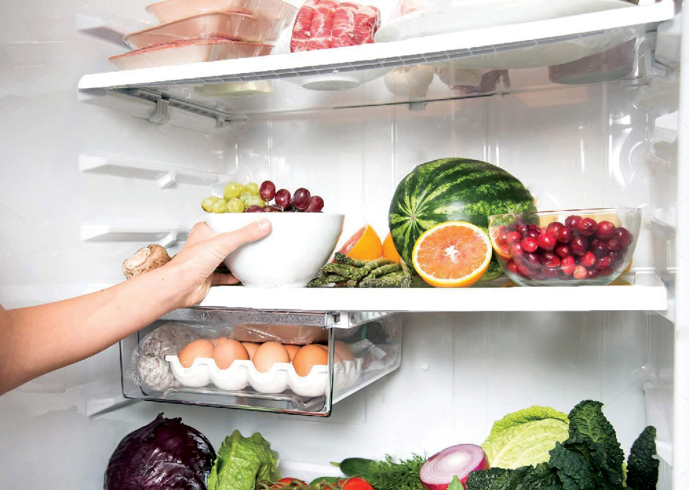 stock-photo-hand-reaching-for-green-apple-in-refrigerator-full-of-healthy-food-options-123345682