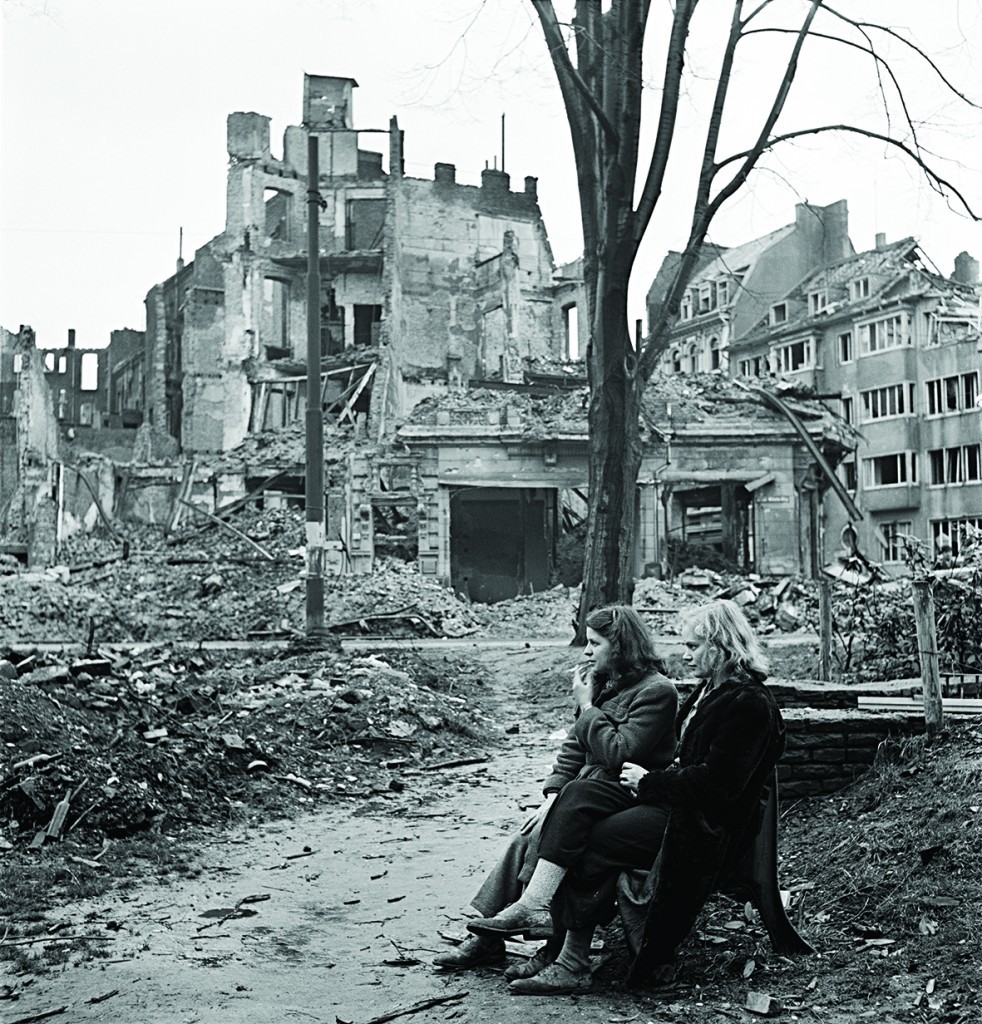 Two-German-women-sitting-on-a-park-bench-surrounded-by-destroyed-buildings-Cologne-Germany-1945-by-Lee-Miller-982x1024