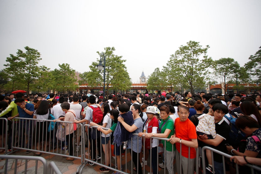 People line up to enter the Shanghai Disney Resort after the opening ceremony of the Shanghai