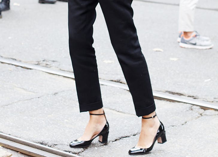woman-wearing-black-pants-and-ankle-strap-pumps