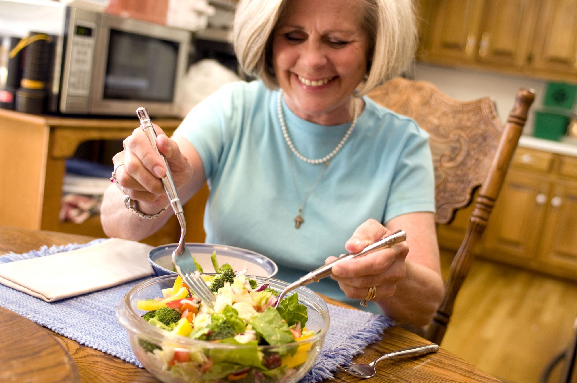 happy-woman-eating-vegetable-salad