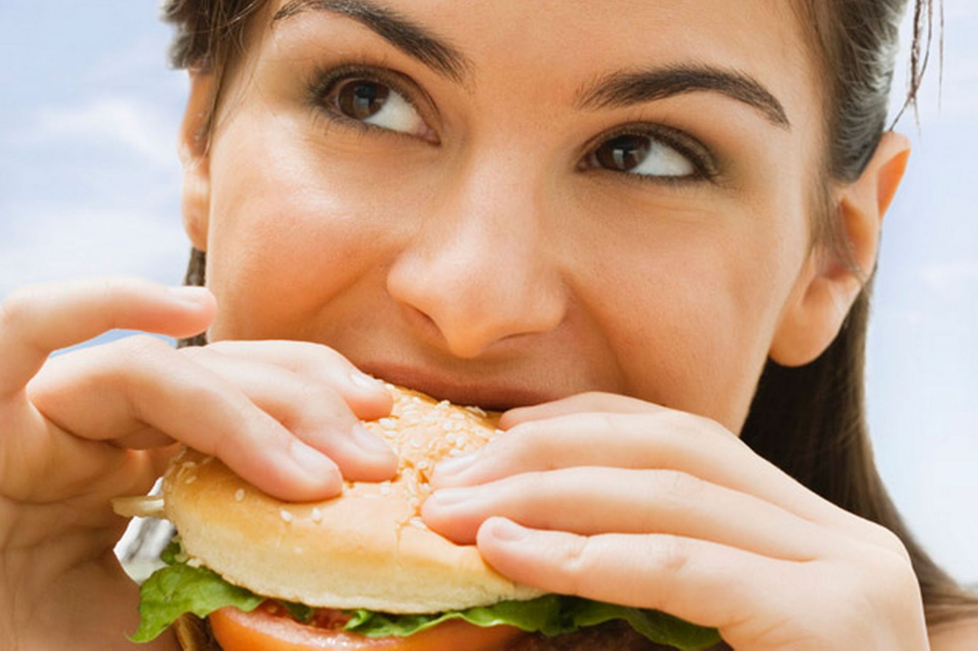 teenage-girl-eating-a-hamburger-692189