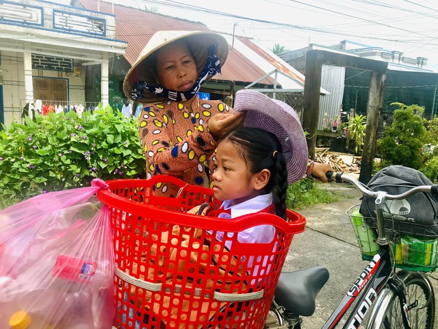 Người bà miền Tây đưa cháu nội bệnh xương thủy tinh đến trường bằng chiếc rổ - Ảnh 1. Người bà miền Tây đưa cháu nội bệnh xương thủy tinh đến trường bằng chiếc rổ - Ảnh 1.