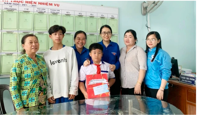 Chị Nguyễn Trang Anh Thư, Phó bí thư Tỉnh đoàn Bạc Liêu (thứ 3 từ phải qua), tặng quà cho trẻ mồ côi do Covid-19 Ảnh: TRẦN THANH PHONG