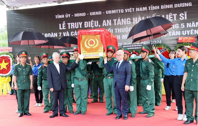 Nguyên Chủ tịch nước Nguyễn Minh Triết (trái) tham gia lễ truy điệu, an táng các anh hùng liệt sĩ