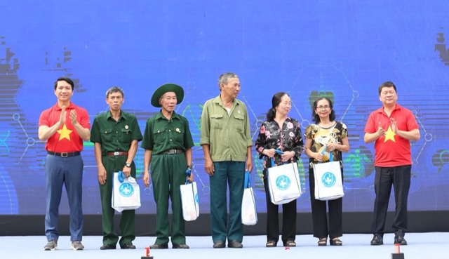 Anh Nguyễn Ngọc Lương (bìa trái) tặng quà cho những người thuộc diện chính sách