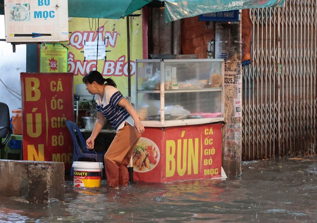 Đường phố Hà Nội ngập sâu sau cơn mưa lớn, phương tiện 'bơi' trong biển nước - Ảnh 12.