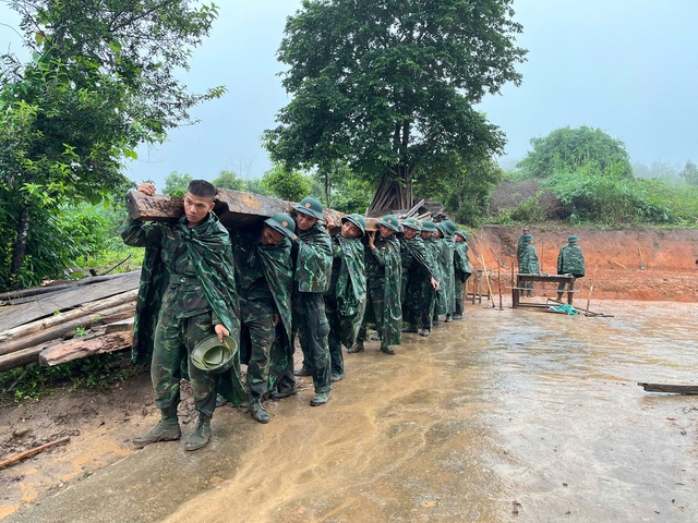 Những người lính trẻ đội mưa sửa nhà rông, vá lại đường- Ảnh 1.