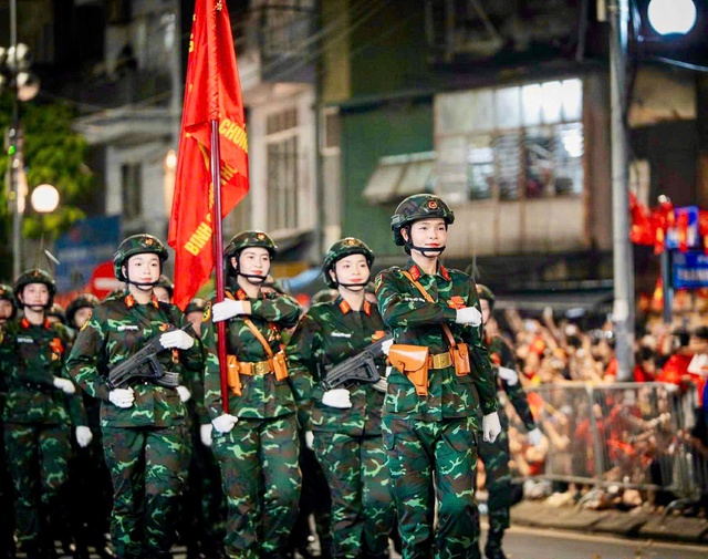 

Trinh (đi đầu) là 1 trong 2 khối trưởng của khối nữ chiến sĩ thông tin  