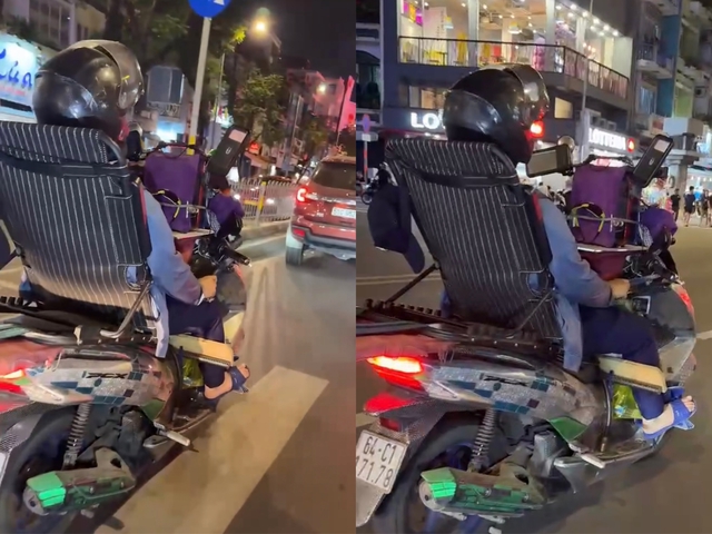 CSGT tịch thu xe của người buông 2 tay, ngả lưng vào ghế khi lái xe máy - Ảnh 1.