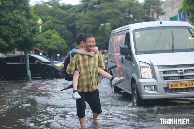 Mưa lớn giờ tan trường, nhiều học sinh ở TP.HCM lội nước về nhà - Ảnh 10.