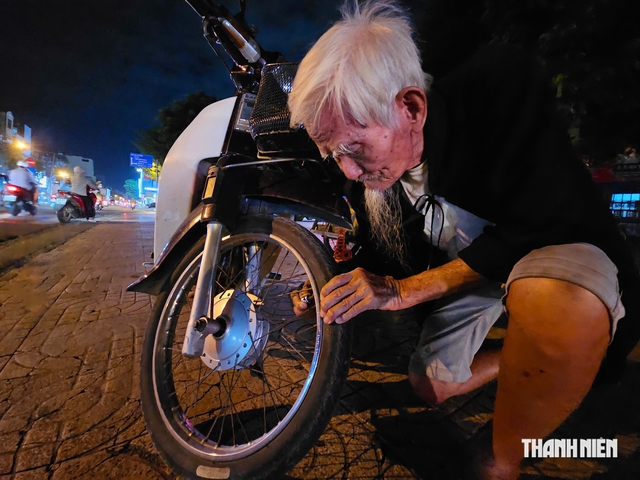 Cụ ông 91 tuổi bơm vá xe nuôi vợ liệt và các con tâm thần - Ảnh 1.