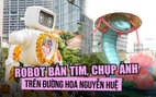 Robot bắn tim, chụp ảnh cho khách trên đường hoa Nguyễn Huệ