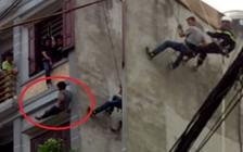 Một người đàn ông đu mình trên tầng 5 đòi tự tử