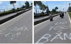 CSGT TP.HCM xóa dòng chữ 'bắn tốc độ' trên mặt đường Lê Quang Đạo