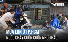 Mưa lớn ở TP.HCM khiến nhiều đường ngập sâu, nước chảy cuồn cuộn như thác