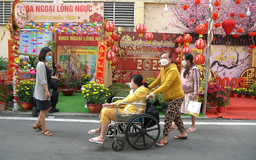 Bệnh nhân ngồi xe lăn ngắm đường hoa tại Bệnh viện Chợ rẫy