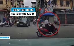 Dân mạng ngao ngán ‘nữ ninja’ vừa lái xe máy vừa cầm dù, vượt luôn đèn đỏ