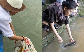 Trương Thị May đi thuyền thả cá phóng sinh trên sông Đồng Nai