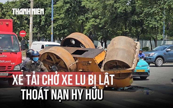 Hy hữu: Xe tải chở xe lu bất ngờ lật trên đường, 2 người thoát nạn gang tấc
